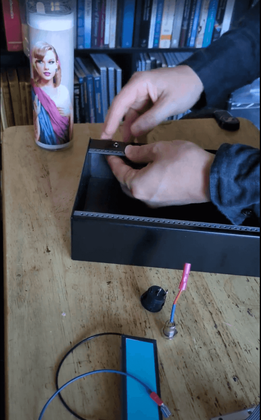 Stephen assembling a case in front of a Taylor Swift candle